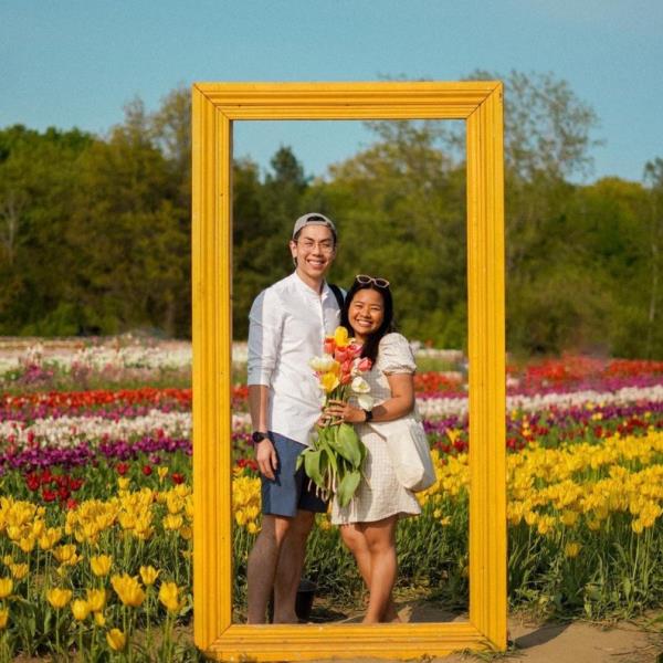 Couple in a wooden frame on the tulip pick farm